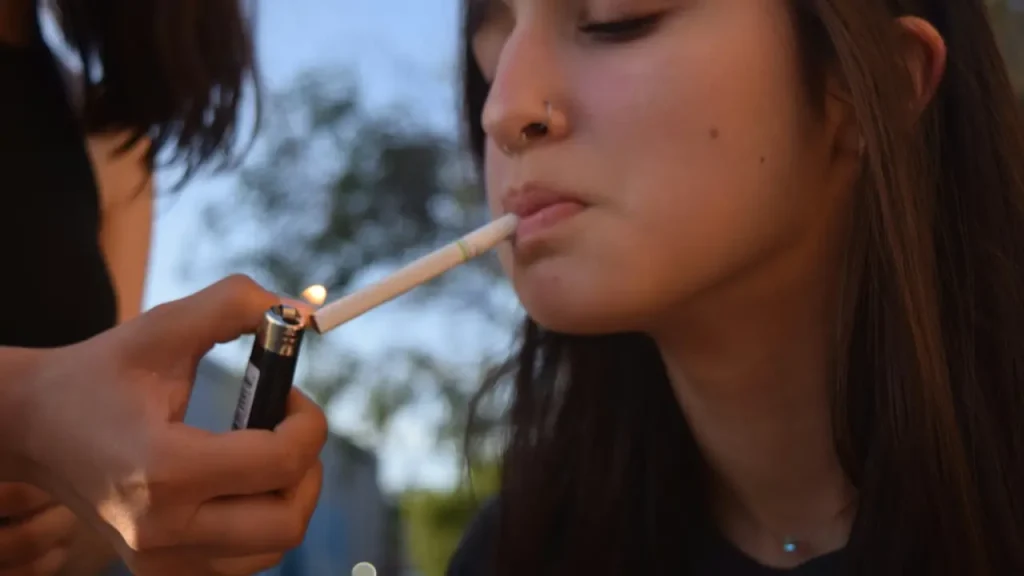 Smoking Relapse image of a girl lighting a cigarette